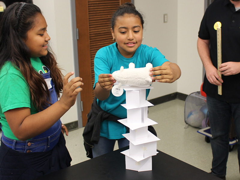 young learners building a tower from index cards