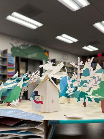 pop up book open to see winter landscape with snowman