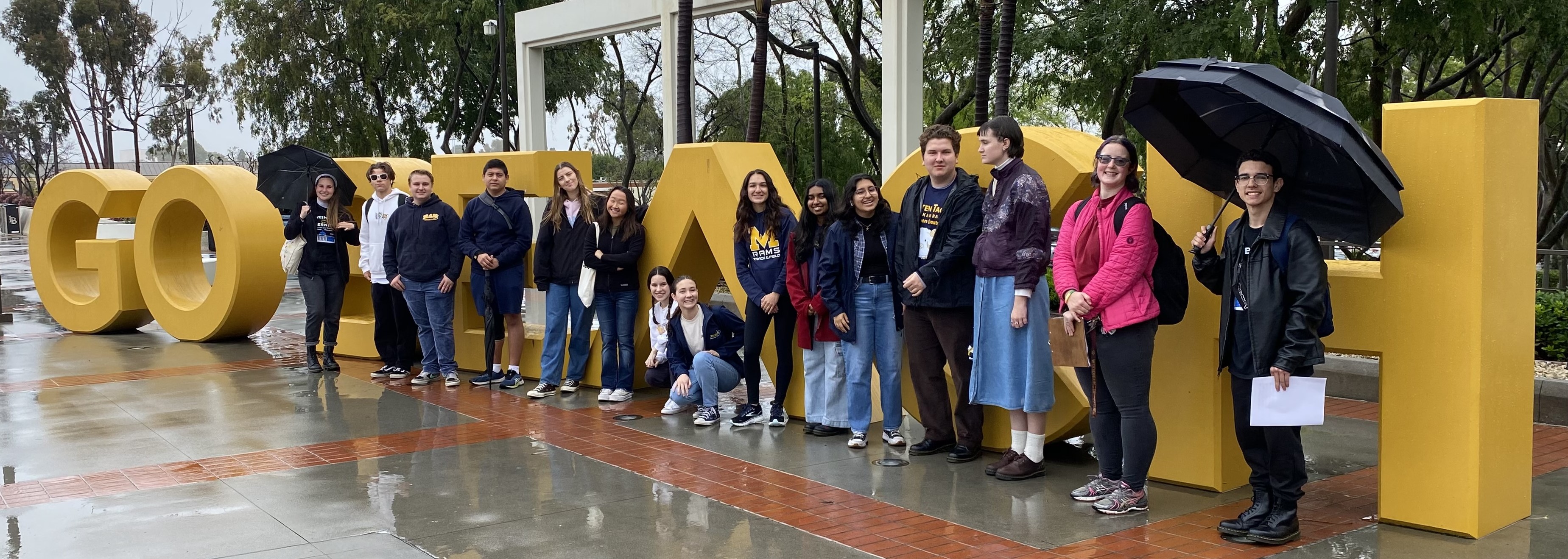 German Studies Students in front of Beach Sign