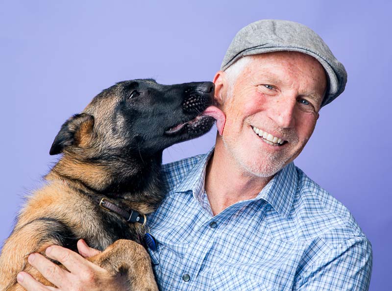 Robert Armstrong poses with their dog Vixen, while the seven