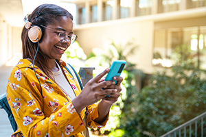 woman smiling looking at phone