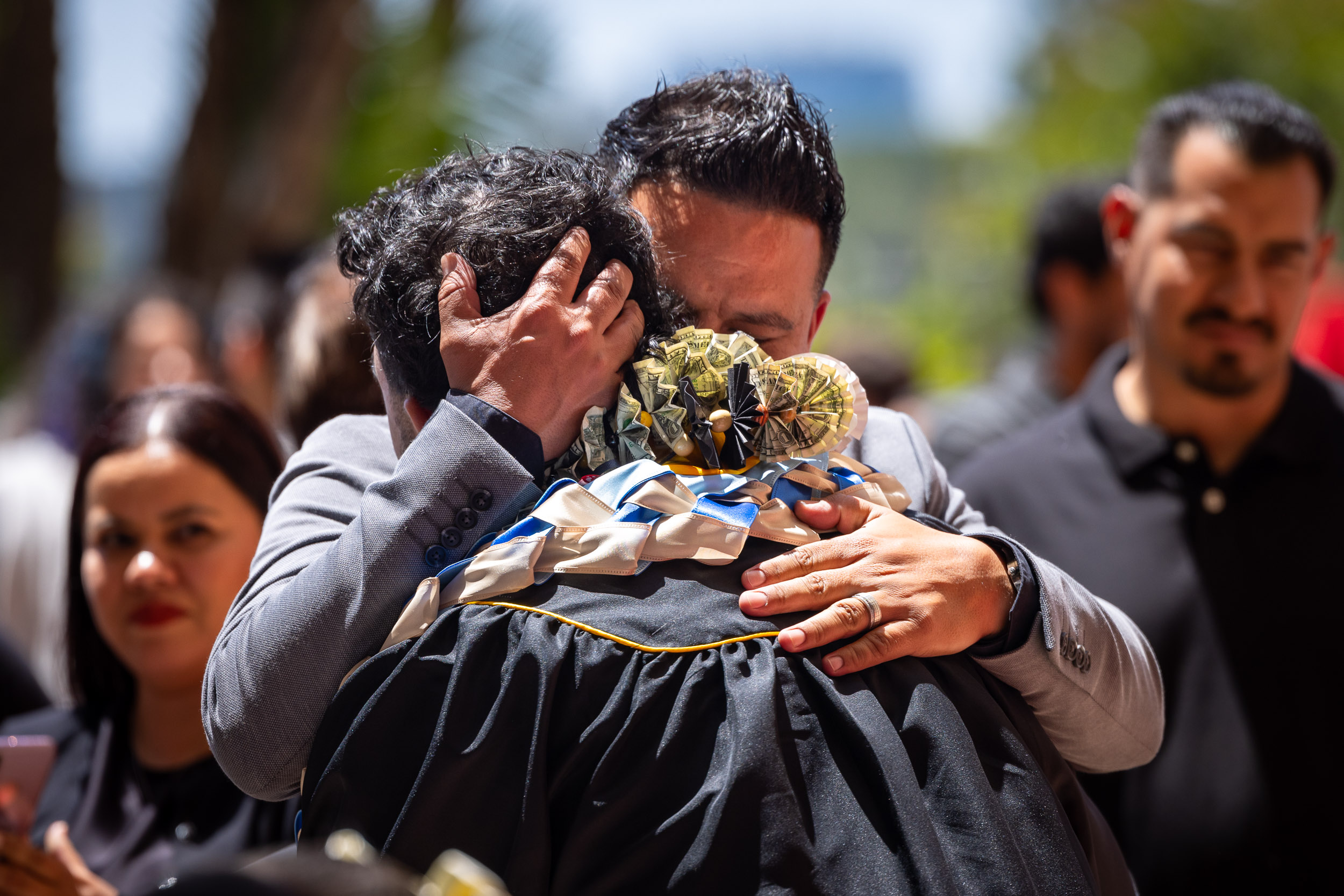 Relative hugs a graduate at Commencement