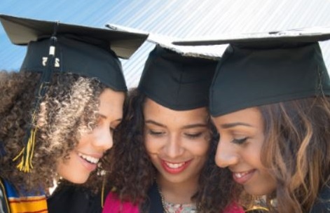 Image of 3 students with graduation caps