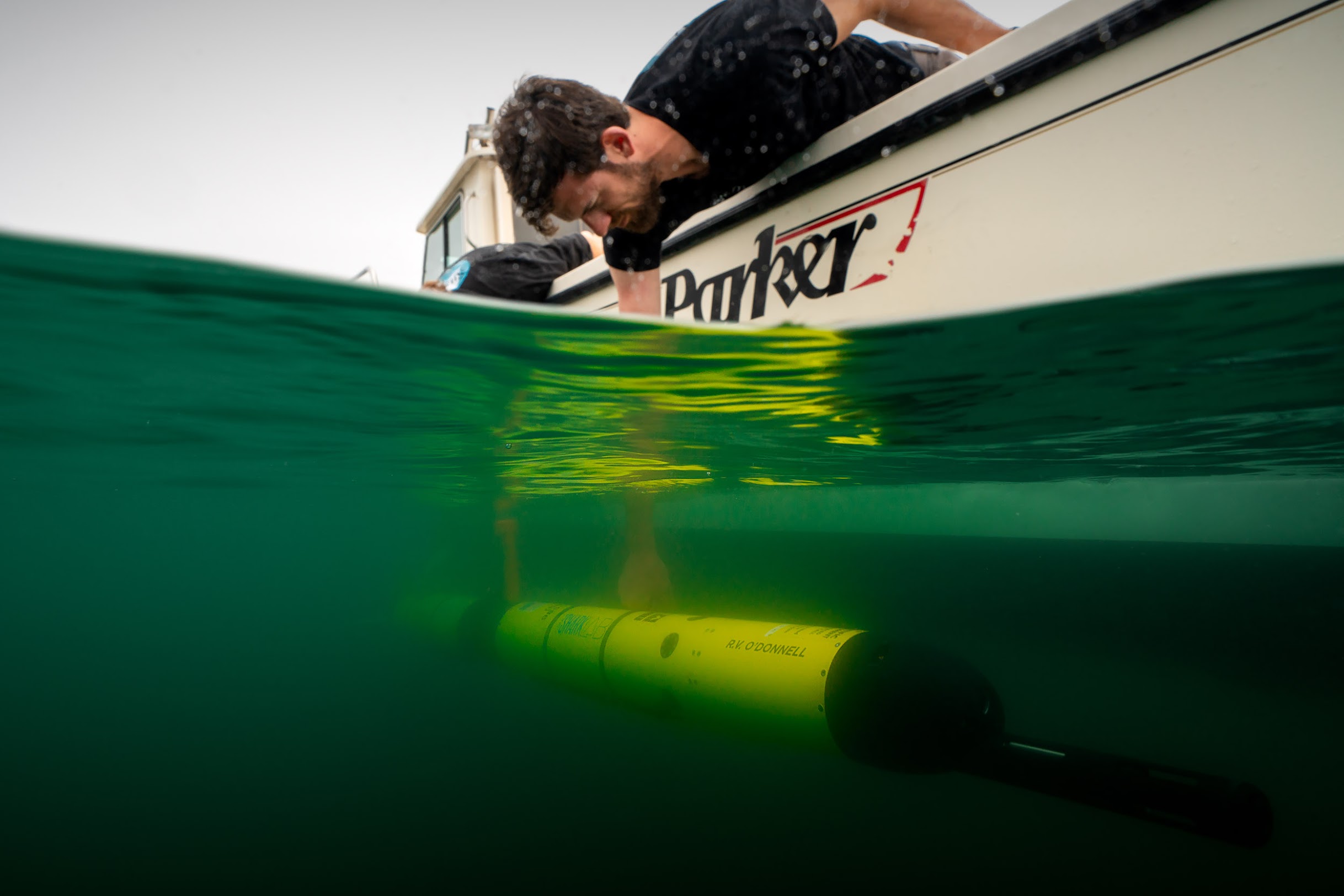 researcher deploying an AUV in the water