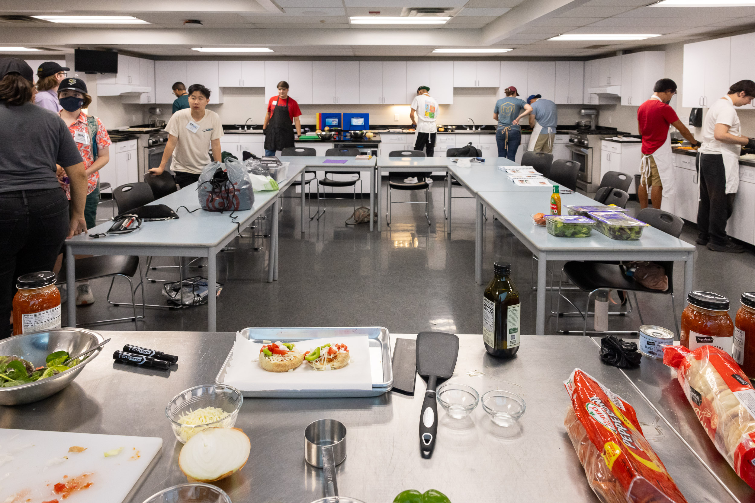 Summer LIFE students and staff prepare lunch in a campus kitchen.