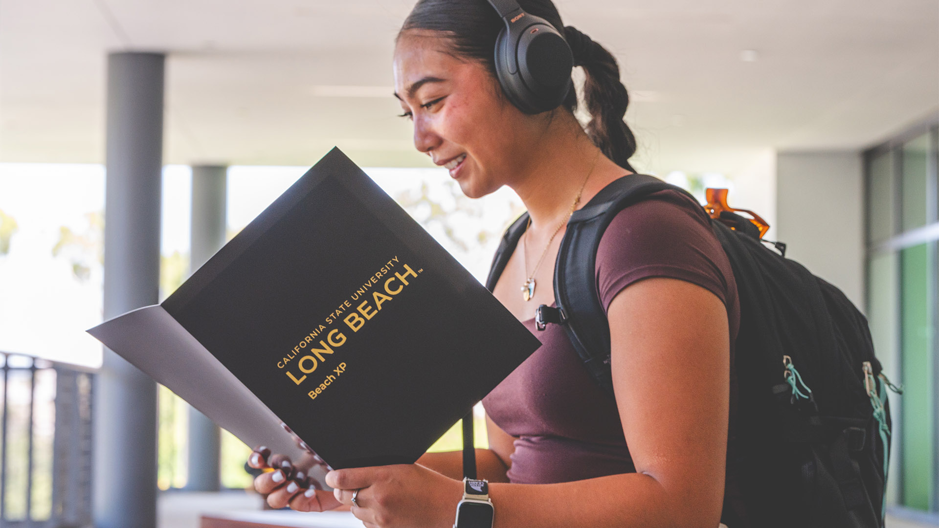 CSULB student looking at a Beach XP folder.