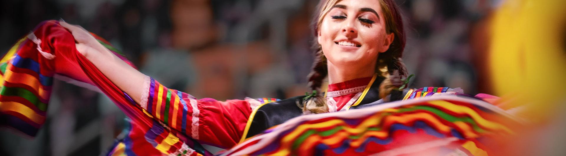 cultural Latine dancer twirling in a dress dress during the cultural graduation