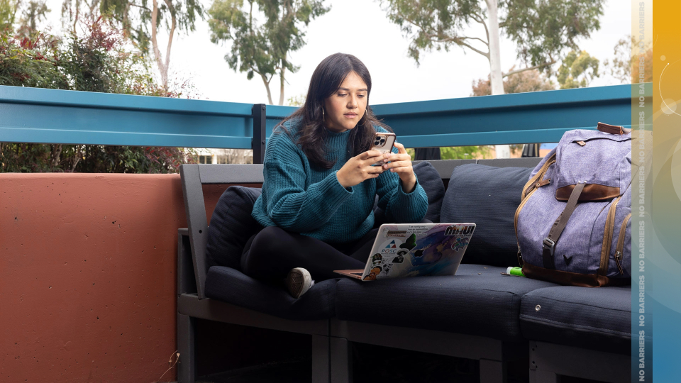 Female student studying while on her phone