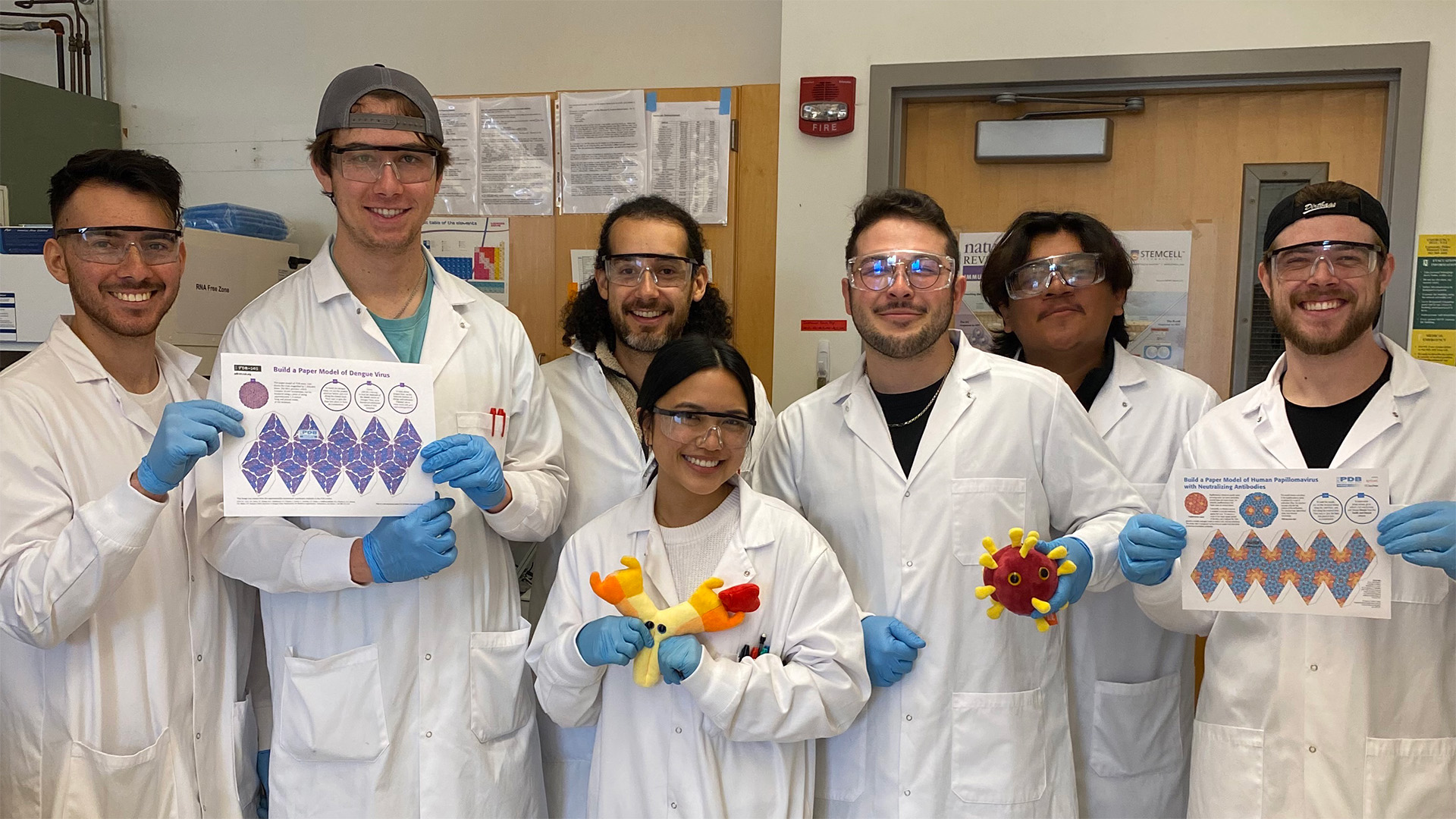 Ramirez Lab members in lab coats with teaching aids