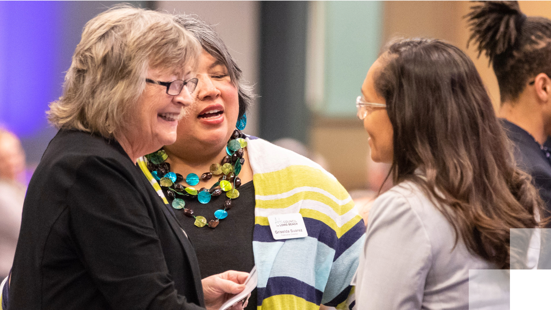 President Conoley shakes hands with woman. 