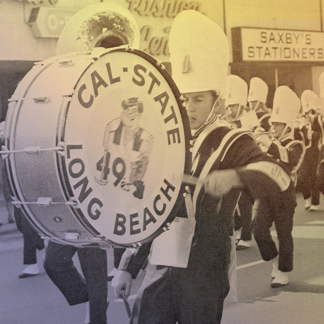 A drummer and marching band on a city street