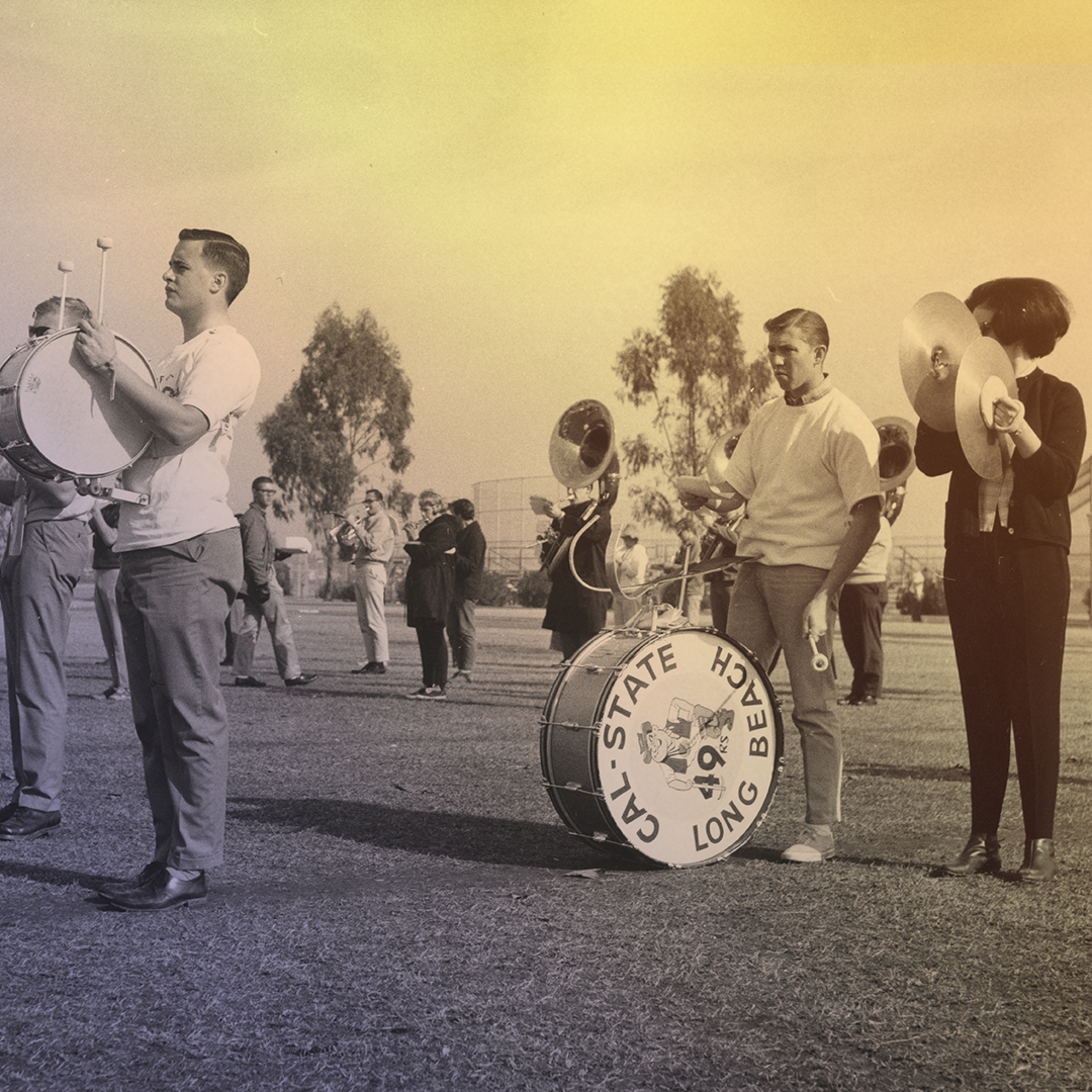 Band members, with drummers and a cymbal player in front, practicing