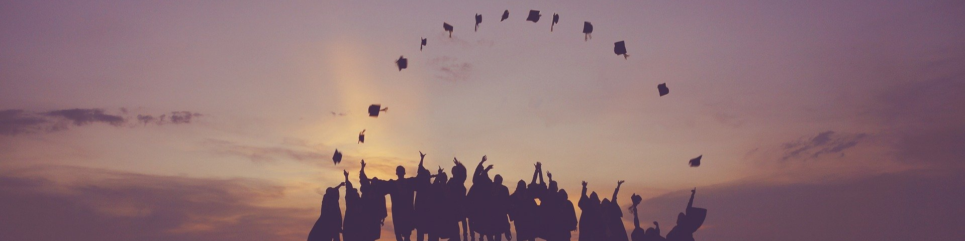 group throwing their graduate caps