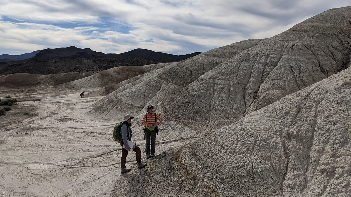 earth science students examining hillside with geologic features