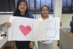 interns holding I love LB poster