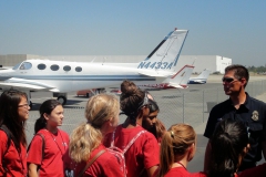 interns in front of plane