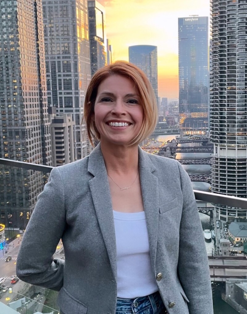 Kim Kelly infront of city skyline at sunset