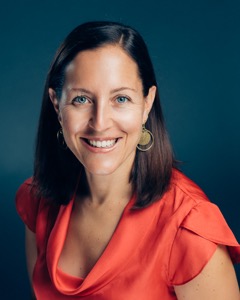 Lauren Heidbrink headshot with blue background 