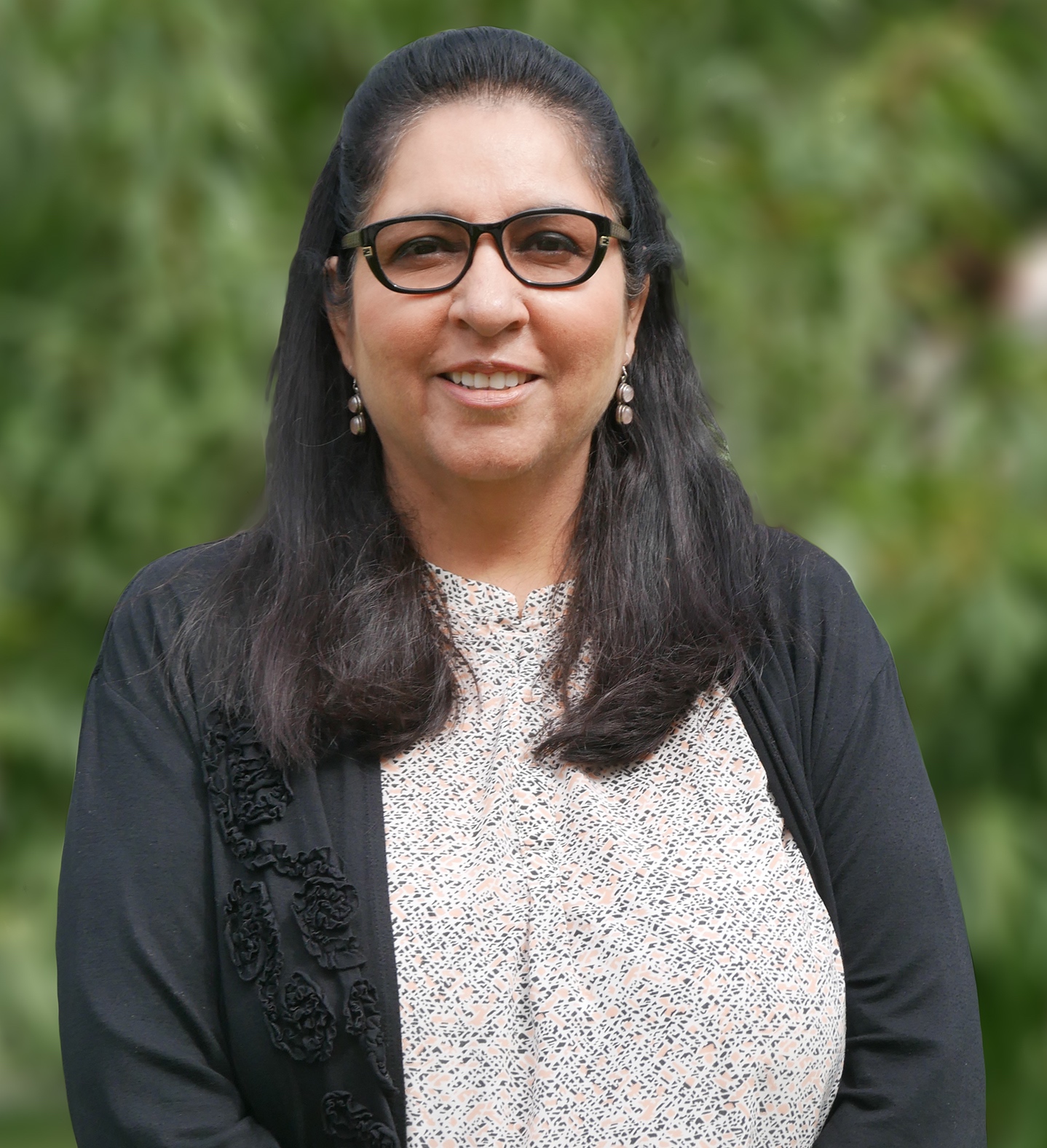 Dr. Rachna Soni in front of greenery