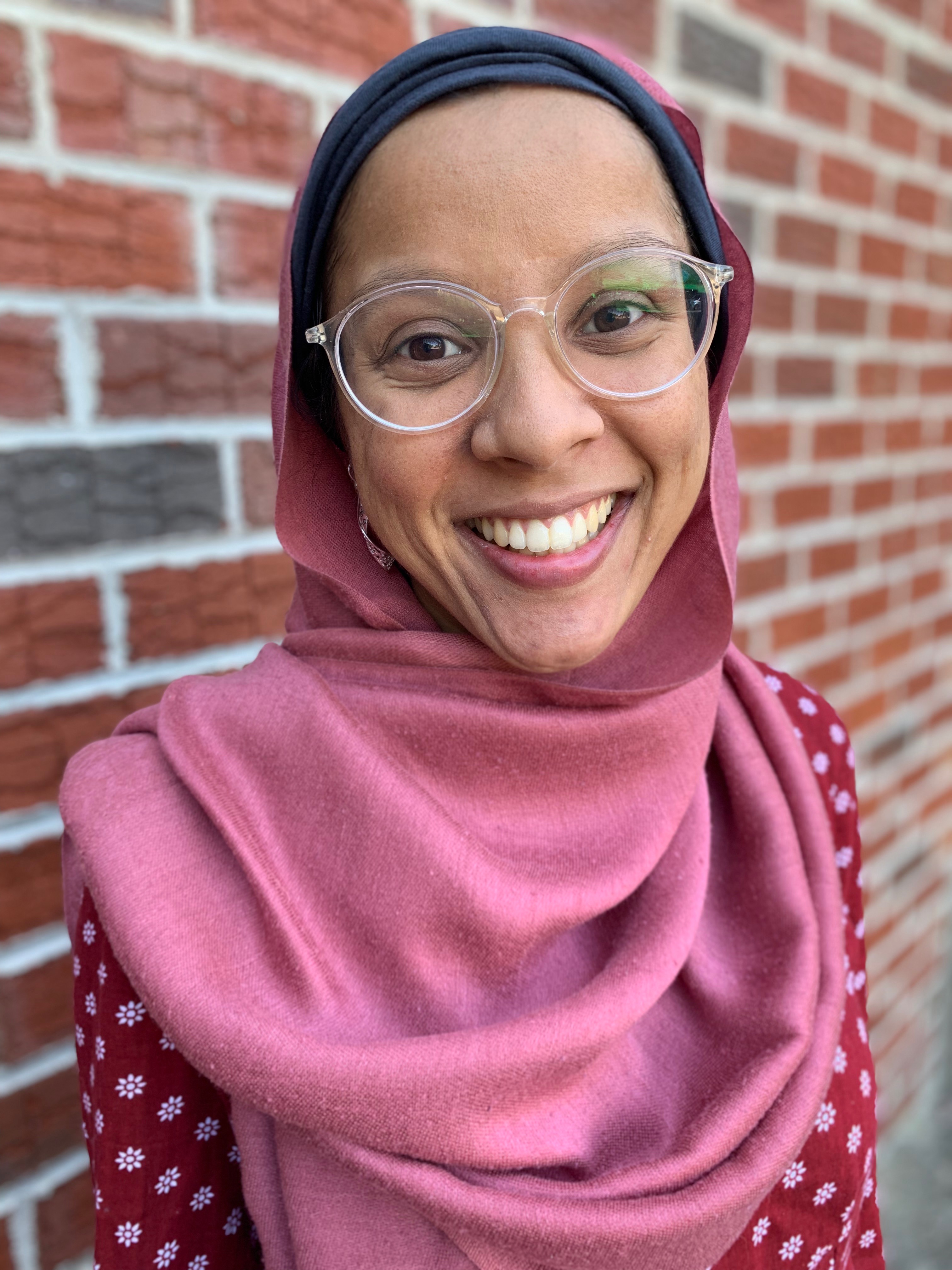 Dr. Samiha Rahman in front of brick background