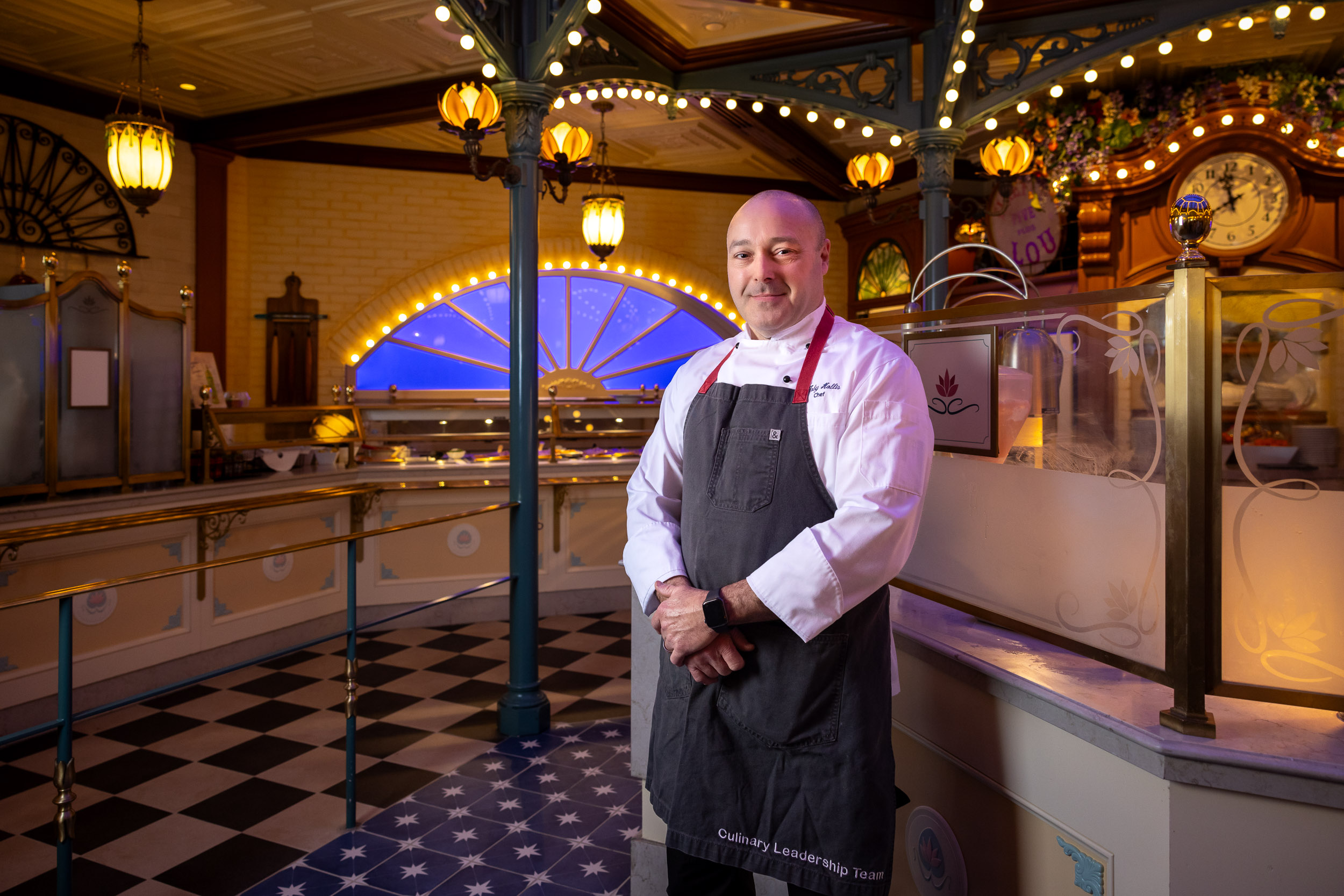 Toby Hollis stands in a Disneyland restaurant