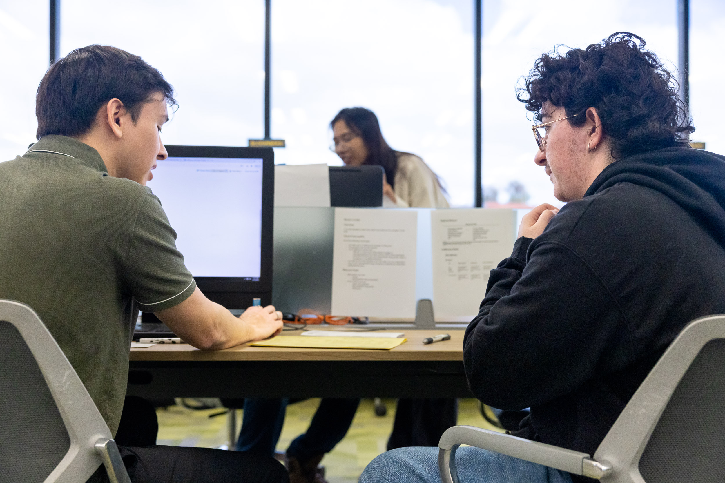 An accounting student, left, helps a fellow student with a tax filing at the VITA lab.