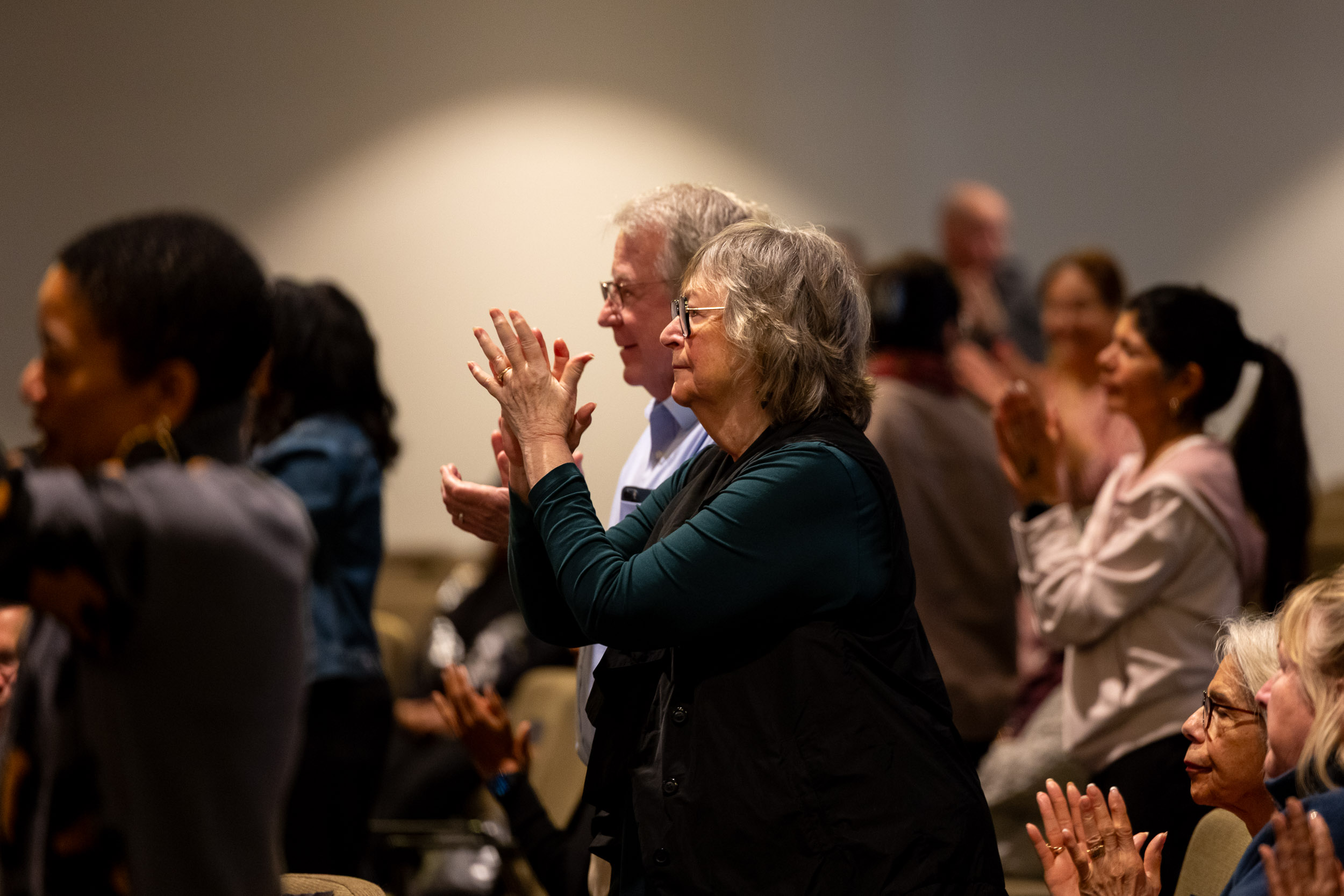 CSULB President Jane Close Conoley and her husband, Collie, stand and clap while watching the Community Gospel Choir Concert