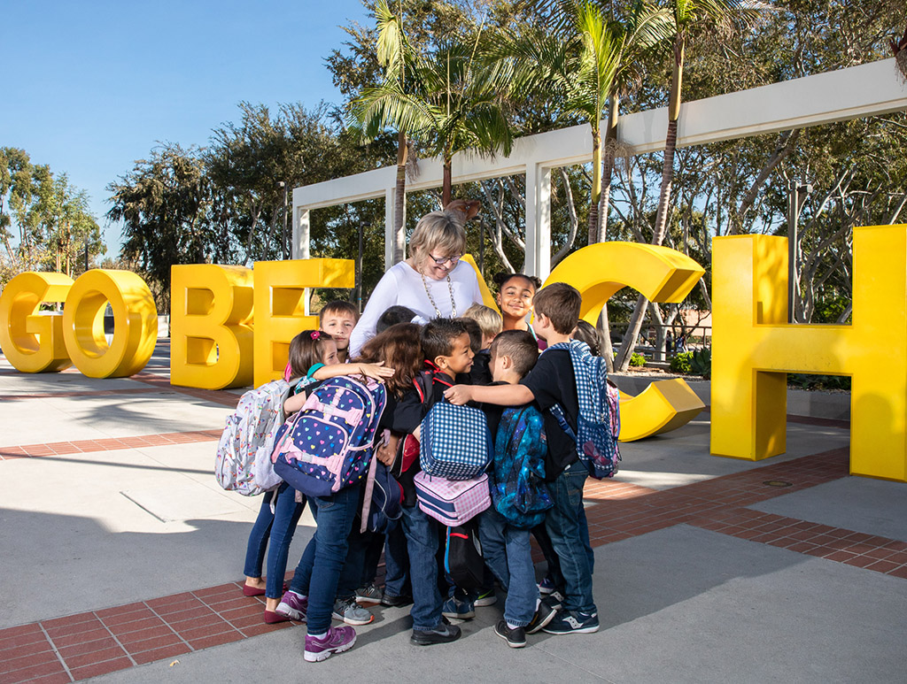 President Conoley with Kids in front of Go Beach