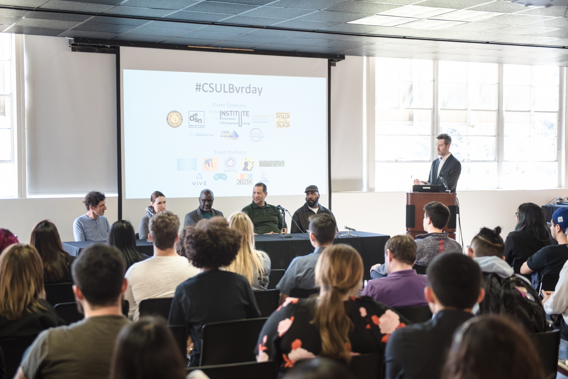 Four Panelists speaking to the event participants in the Dun