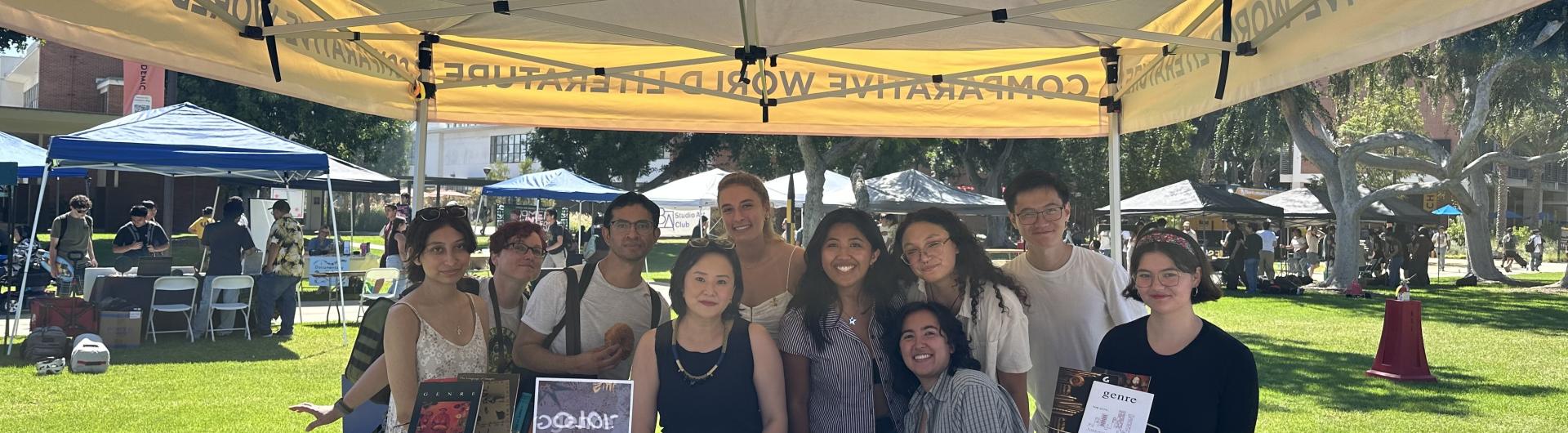 group of students at table under CWL banner