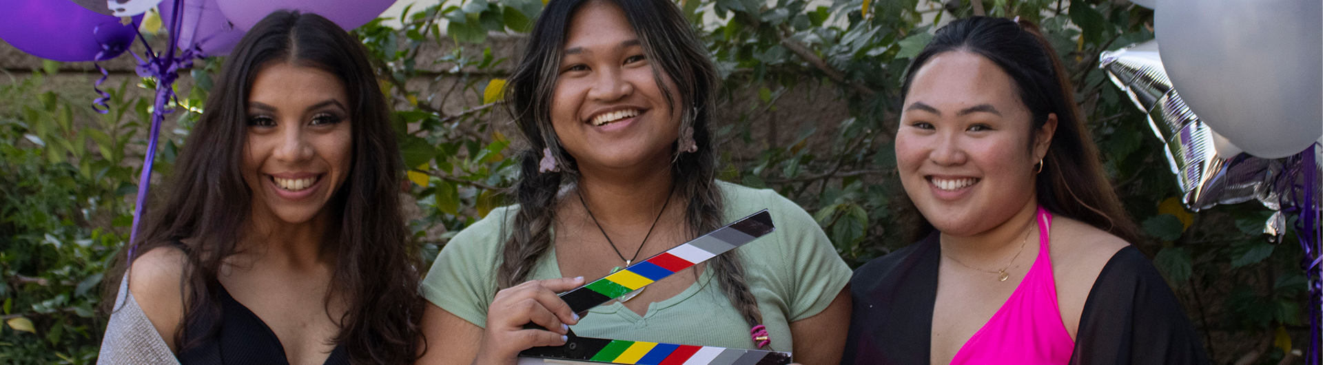 Students on film set holding film clapperboard