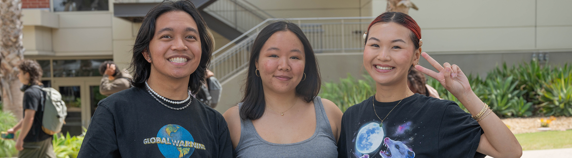 Three Asian American students posing for a photo together at the Asian, Pacific Islander, and DESI (APID) cultural welcome