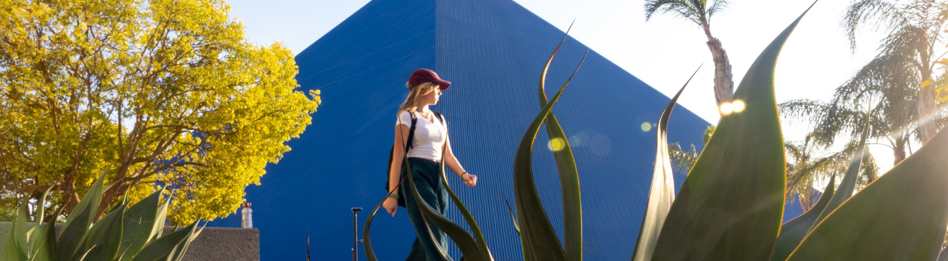Girl walking past The Pyramid on campus