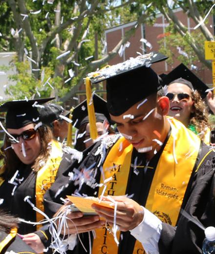 graduates walking through confetti