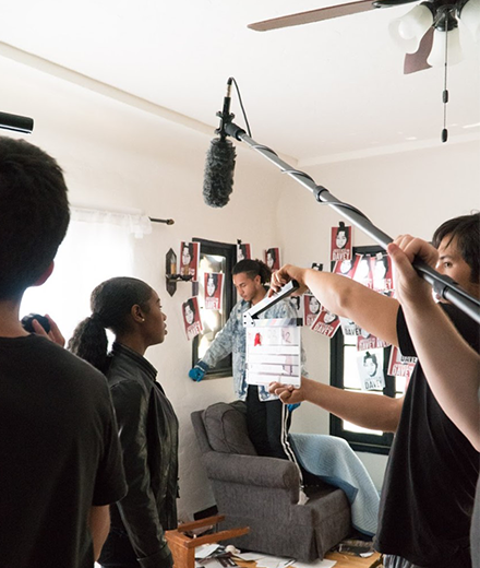Film Students Holding Microphone and Camera On Set
