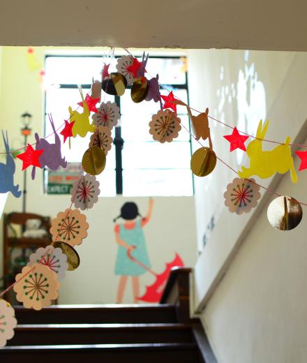 Picture of a school hallway with brightly colored paper garlands hanging from the ceiling