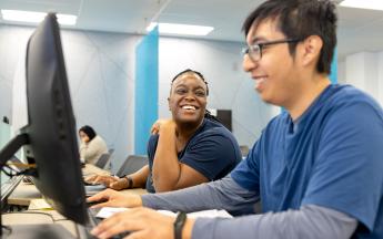 Student in COB LAB helping with a Man with Tax Service