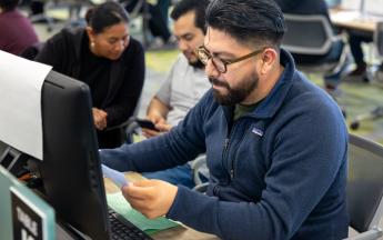 Student in COB LAB helping with a family with Tax Service