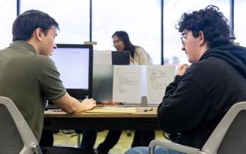 Student in COB LAB helping with a Gentleman with Tax Service