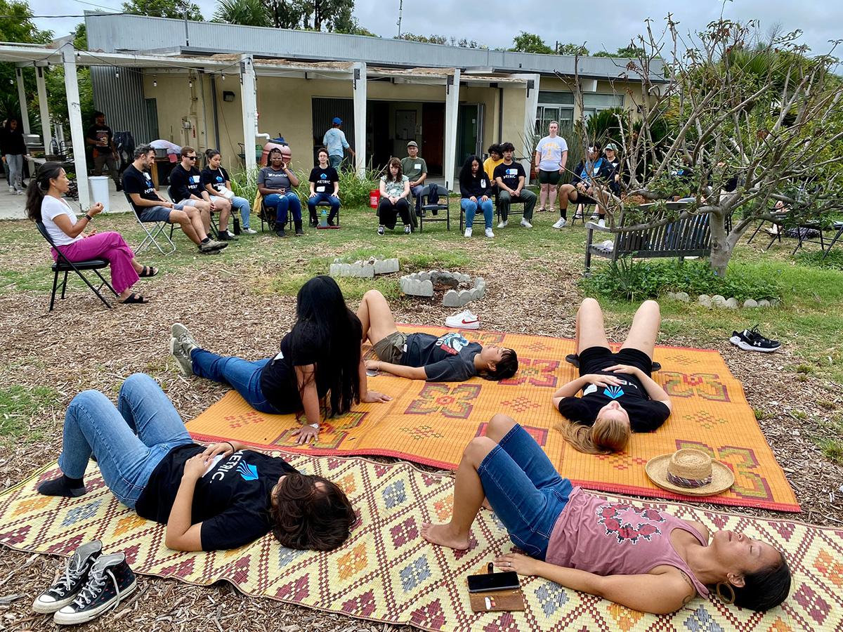 students meditating on blankets