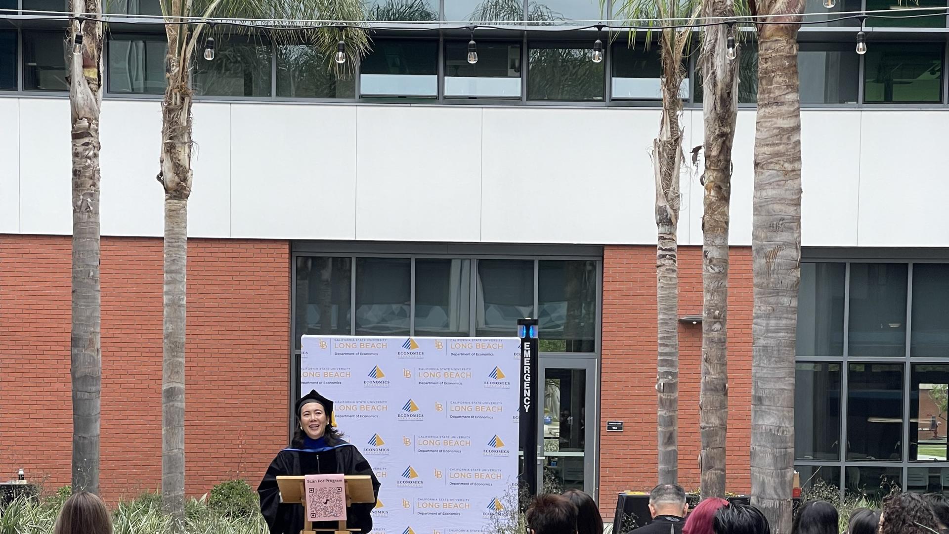  Dr. Yutian Chen opening the Celebration in the SSPA Courtyard in front of the family and friends of the graduating class.