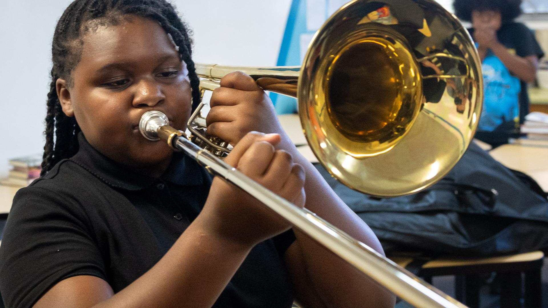 A girl playing a trombone