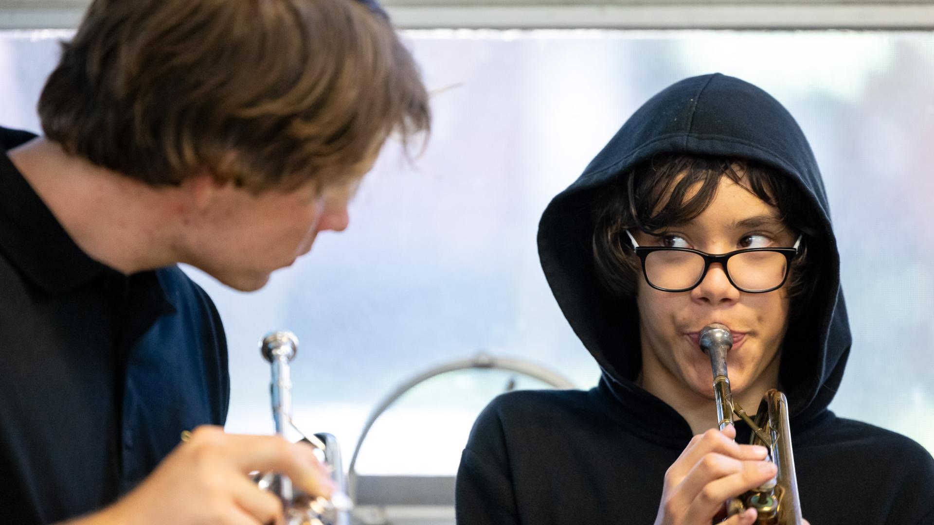 A student practicing music with Ben Rifkin, a CSULB student interning with music education group Jazz Angels.