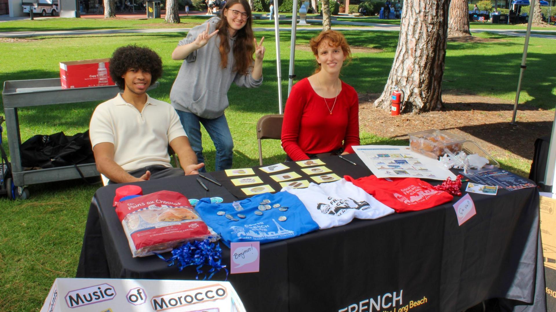 three students tabling at the French studies outreach table