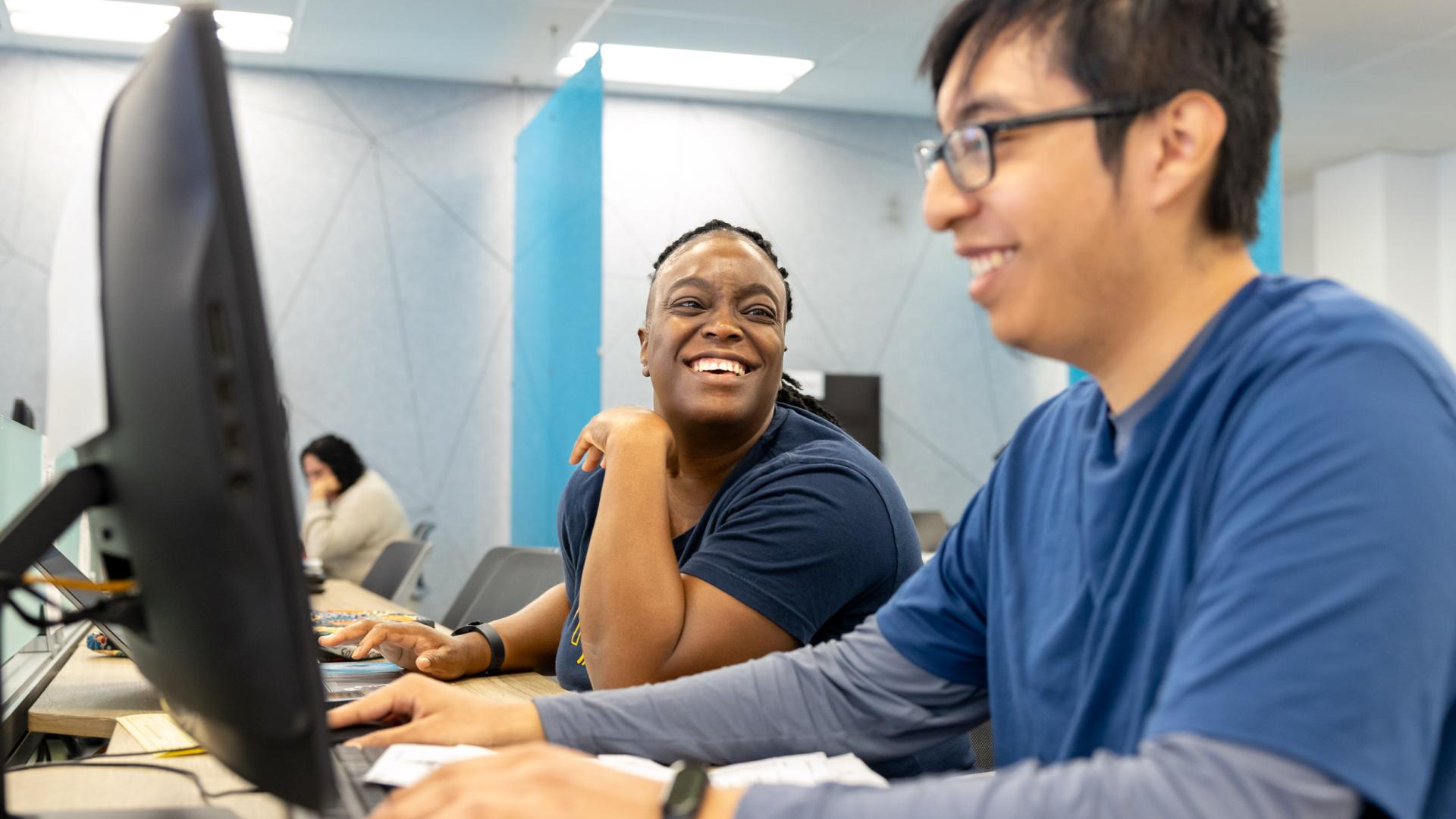 Student in COB LAB helping with a Man with Tax Service