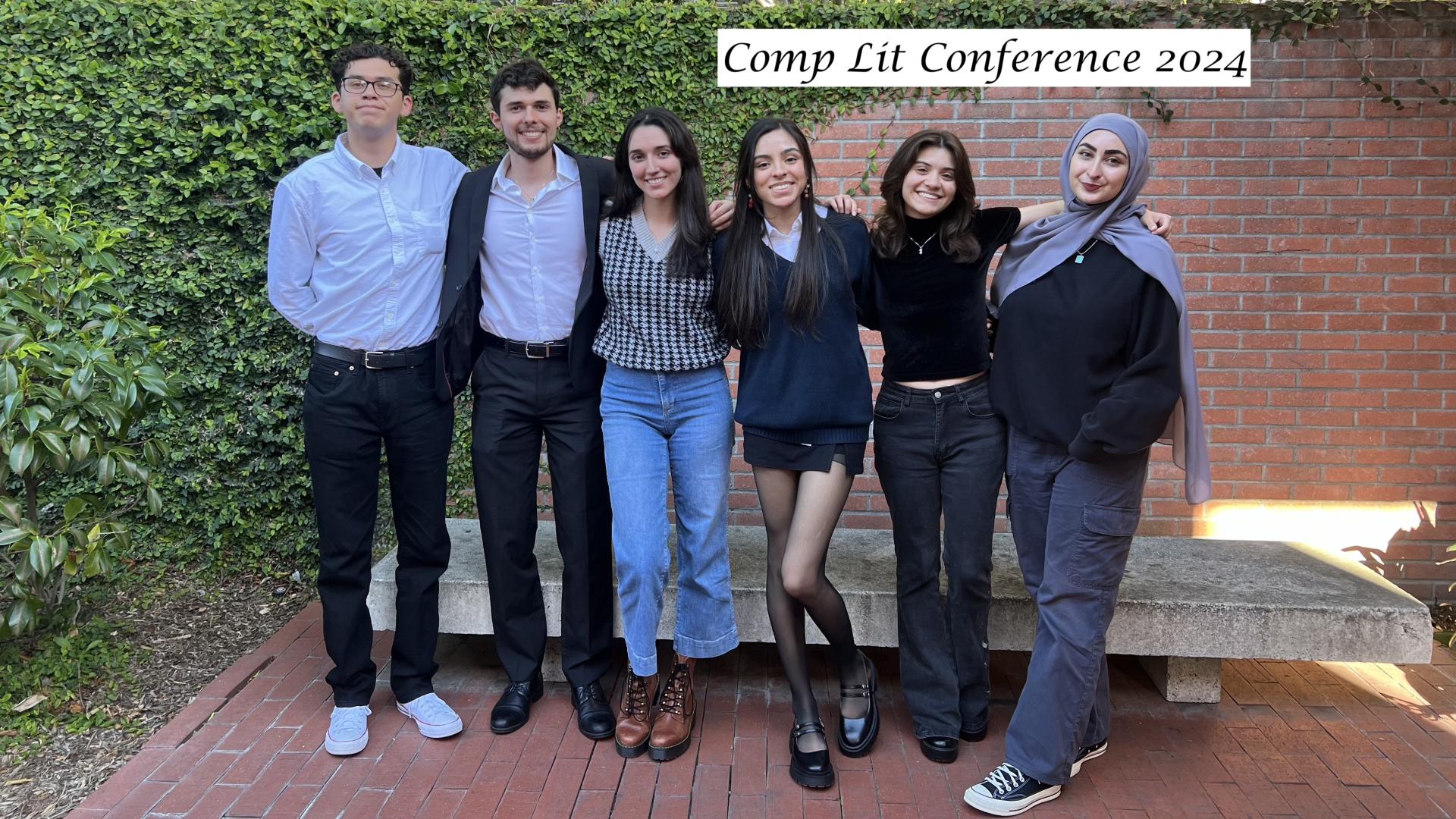 students standing in front of brick wall