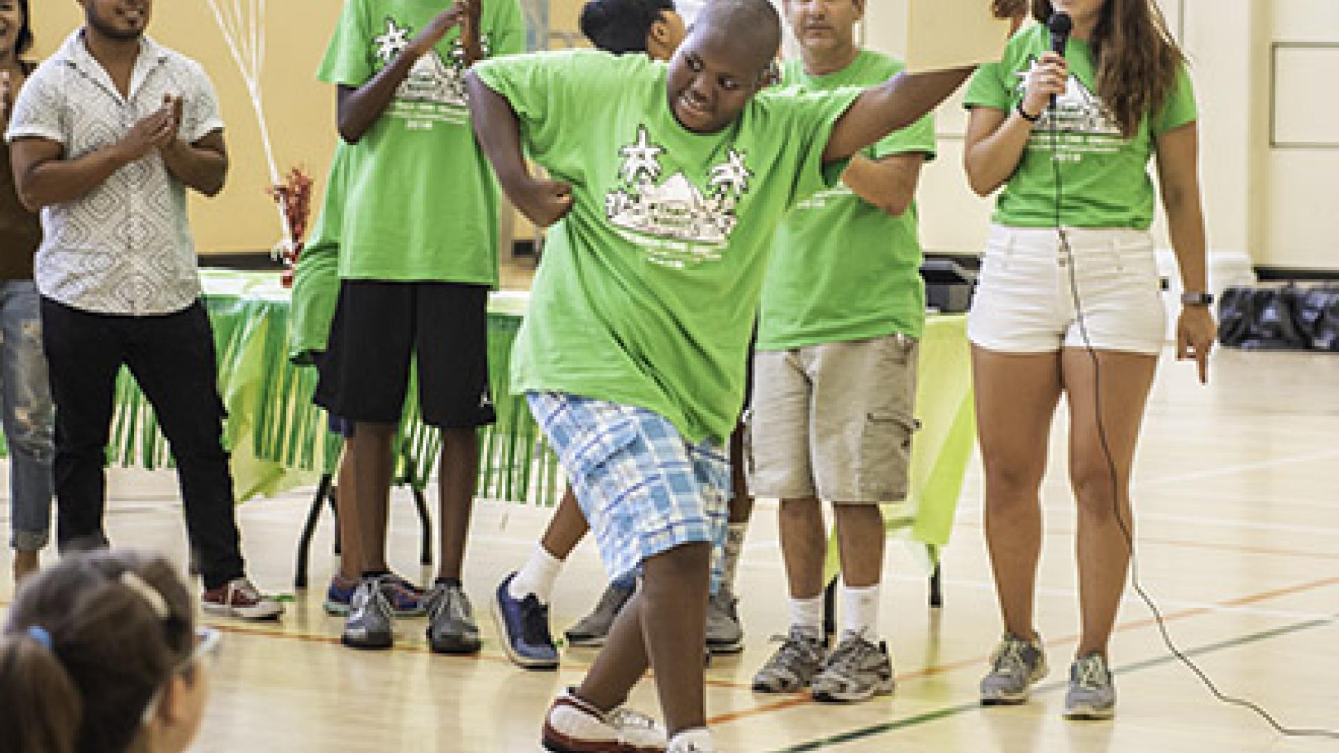 Boy does a dance move at Camp Nugget
