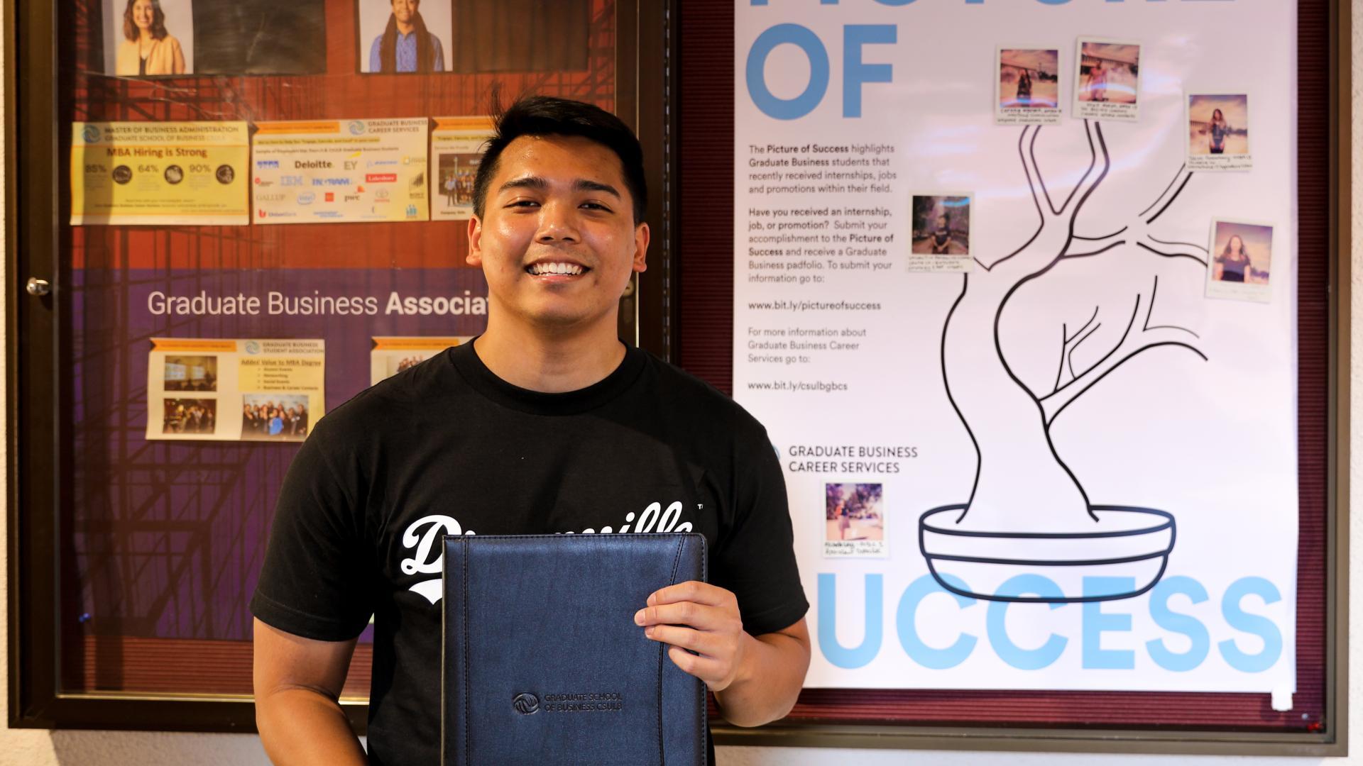 Valentin Joseph Panaguiton in front of the Picture of Success Poster