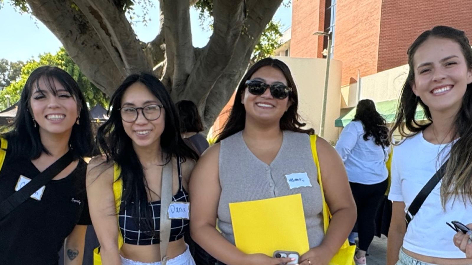 Four students pose for a photo on the CSULB campus