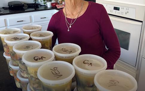 Suzanne Marshall stands near her soup containers